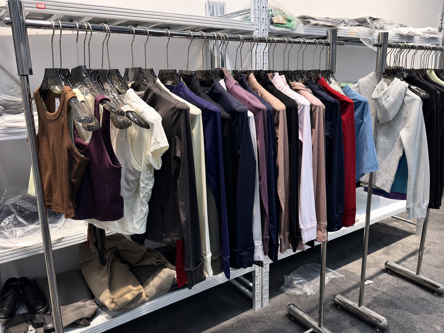 Activewear and clothing samples on warehouse rails